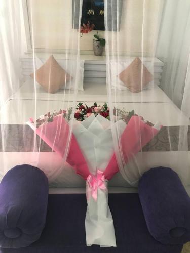 a room with a table with purple pillows and a window at One BedRoom Villa with Private Pool near DPS Airport in Kuta