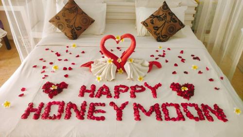 a cake on a bed with a happy honeymoon sign at One BedRoom Villa with Private Pool near DPS Airport in Kuta