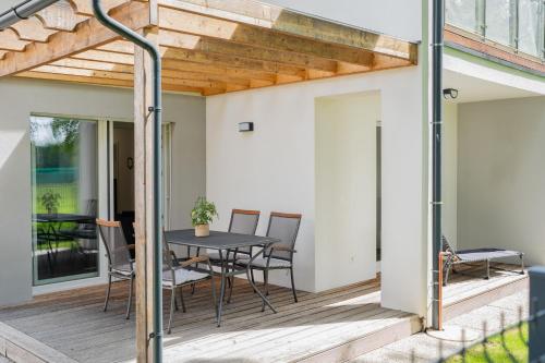 a patio with a table and chairs on a deck at Apartment Swim and Relax in Moravske Toplice