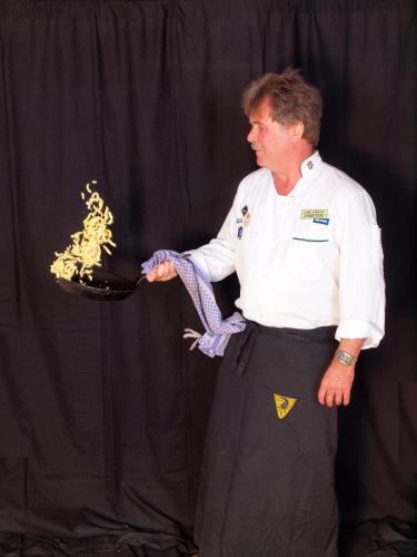 a man is holding a plate of food at Landgasthaus Löwen mit Gästehaus in Holzhausen