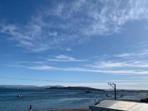 a view of a body of water with boats in it at Casa de Mar in Quellón