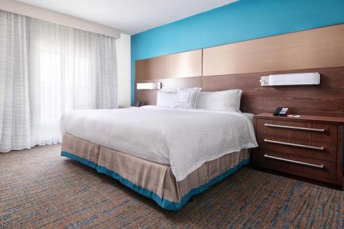 a hotel room with a large bed and a window at Residence Inn by Marriott Houston Pasadena in Pasadena