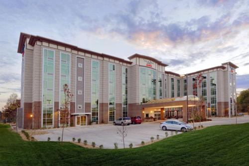 a large building with cars parked in a parking lot at TownePlace Suites by Marriott Springfield in Springfield