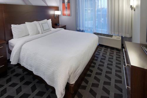 a large white bed in a hotel room at TownePlace Suites by Marriott Springfield in Springfield
