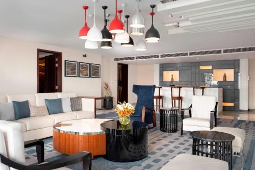 a living room with a couch and chairs and a table at Le Meridien Dhaka in Dhaka