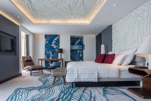 a bedroom with a large bed with red pillows at Le Meridien Dhaka in Dhaka