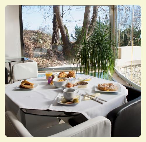 a table with plates of food on top at Nymfes Hotel in Kato Loutraki