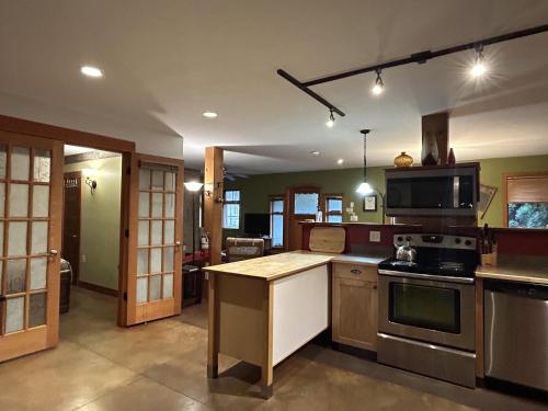 a kitchen with a stove and a counter top at Mistiso's Place Vacation Rentals in Nelson