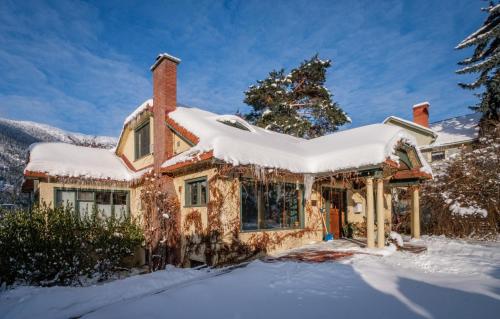 a house with snow on the roof at Mistiso's Place Vacation Rentals in Nelson