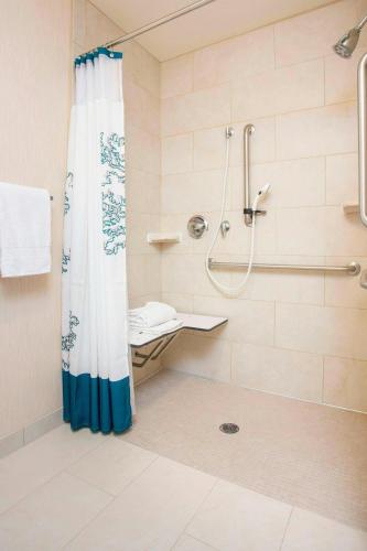 a bathroom with a shower and a shower curtain at Residence Inn Topeka in Topeka