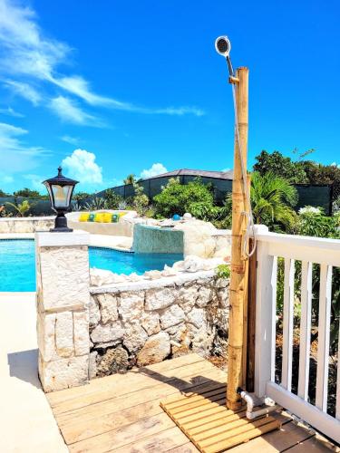 a porch with a gate and a pool at Long Bay View Villa in Leeward