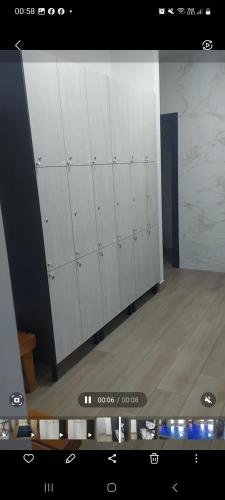 a row of white lockers in a room at Apartman Primus Zlatibor sa bazenom,spa&wellness centrom-Velika recepcija 125 in Zlatibor