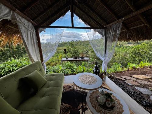 a room with a couch and a table and a window at Laa Cabana Lombok Glamping in Sapit