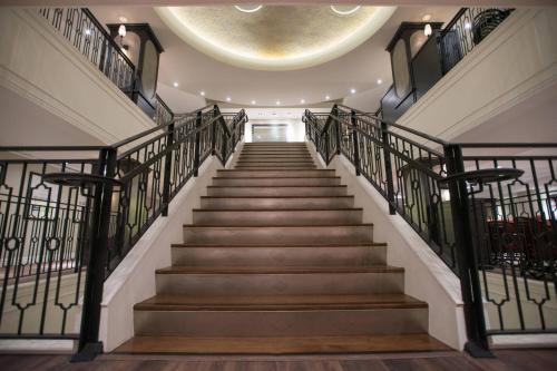 a staircase with metal railings and a circular ceiling at Magnolia Hotel Houston, a Tribute Portfolio Hotel in Houston
