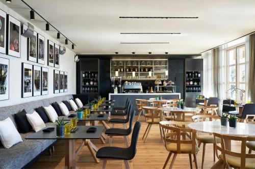 a restaurant with tables and chairs and a bar at Hotel Arts Barcelona in Barcelona