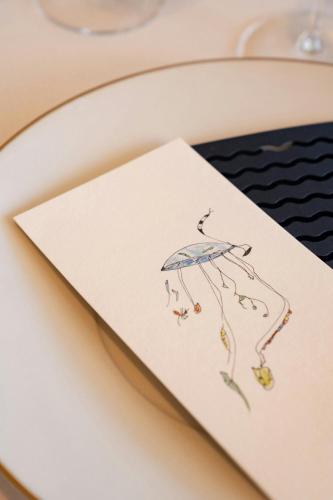 a card with a drawing of a kite on a toilet at Hotel Arts Barcelona in Barcelona