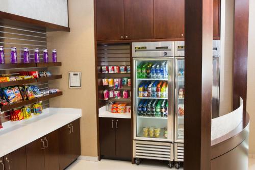 a refrigerator filled with lots of soda and drinks at SpringHill Suites by Marriott Bloomington in Bloomington