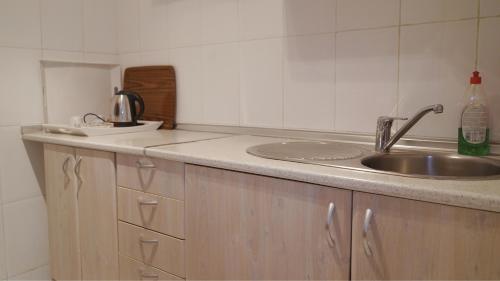 a kitchen with a sink and a counter top at Hôtel Prestige in Nouadhibou
