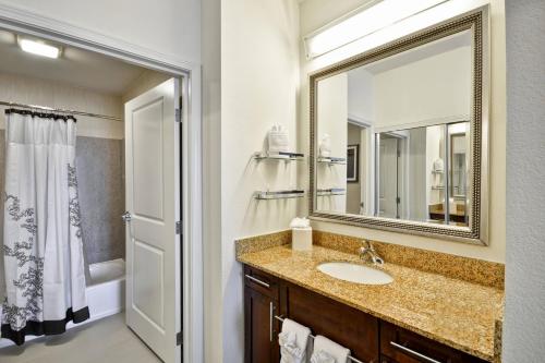 a bathroom with a sink and a mirror at Residence Inn by Marriott Gulfport-Biloxi Airport in Gulfport