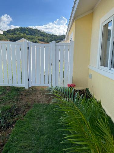 a white fence in front of a house at VillaMerissa Ocenpointe in Point