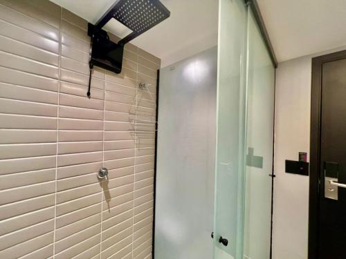 a shower with a glass door in a bathroom at Alta Garden- Pé Na Areia- MH in João Pessoa