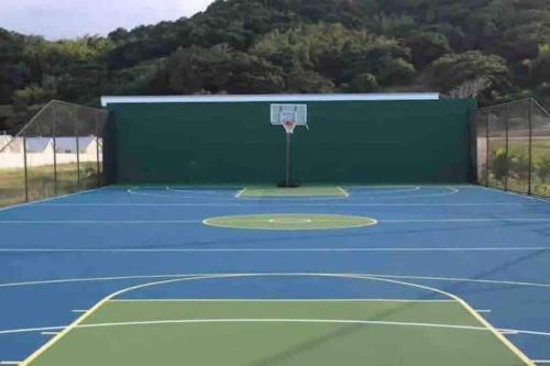 a basketball hoop on a tennis court at VillaMerissa Ocenpointe in Point