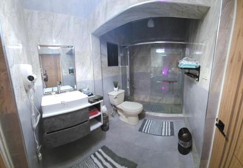 a bathroom with a white toilet and a sink at Addvantage Point Apartments in Montego Bay