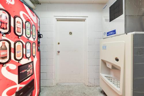 a room with a soda machine next to a door at Motel 6-Kingston, TN in Kingston