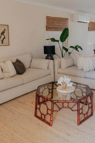 a living room with a couch and a coffee table at Pet Friendly Townhouse in Geraldton