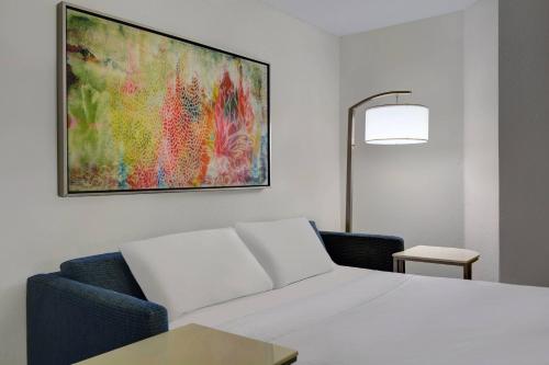 a room with a white couch and a painting on the wall at Springhill Suites Jacksonville in Jacksonville