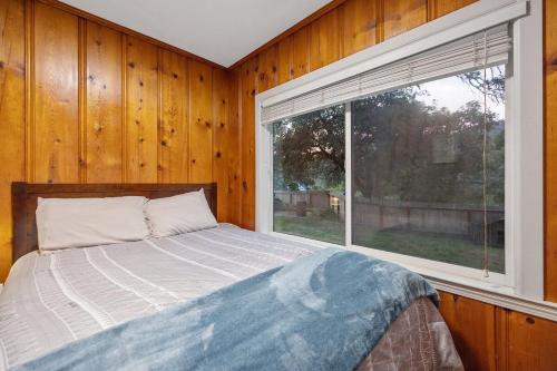 a bedroom with a bed and a large window at 3B Hot Tub, 4mi from Sequoia, Arcade Games, Foosball in Three Rivers