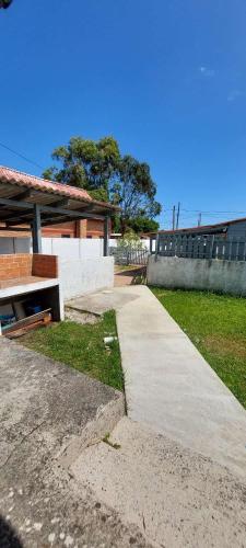 a concrete walkway in front of a house at Yamini - Barra del Chuy in Barra del Chuy