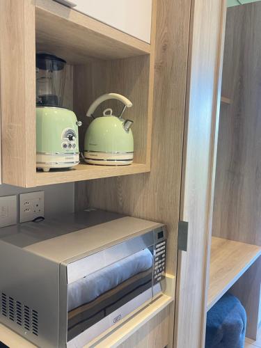a kitchen with a microwave and a toaster at Boulevard suite 242 in Ballito