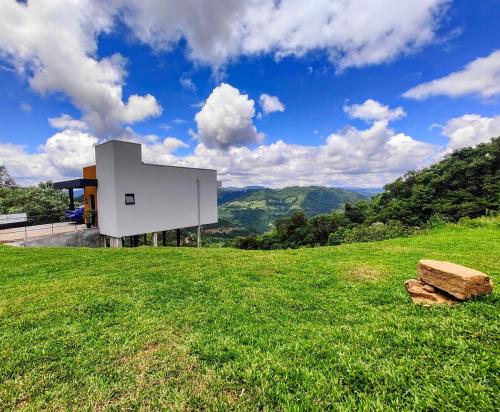a house on a hill with a green field at Sombra na Montanha in Nova Petrópolis