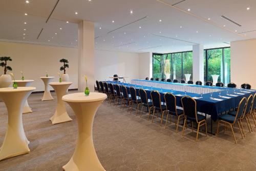 a conference room with a long table and chairs at The Westin Leipzig in Leipzig
