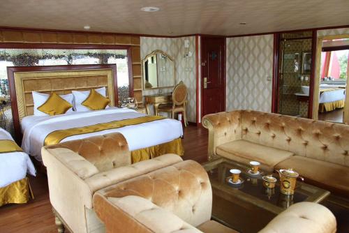 une chambre avec un grand lit et un canapé dans l'établissement Golden Cruise luxury, à Hạ Long