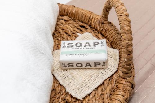a bar of soap in a basket next to a towel at Inn At Fulton Boutique Hotel in Sandusky
