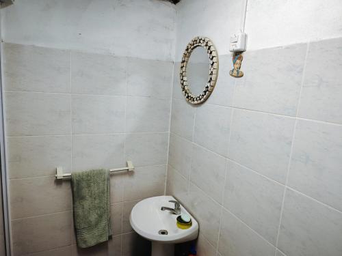 a white bathroom with a sink and a mirror at Espacio 74 Aguas Dulces in Aguas Dulces