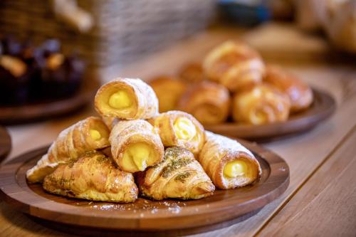a pile of pastries on a plate on a table at Sheraton Grand Doha Resort & Convention Hotel in Doha