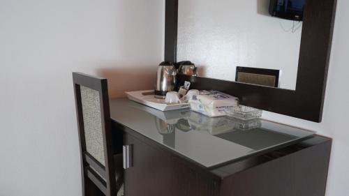 a bathroom counter with a sink and a mirror at Hôtel Prestige in Nouadhibou