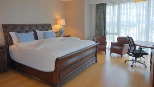 a bedroom with a large bed and a table and chairs at Crowne Plaza Kayseri by IHG in Kayseri