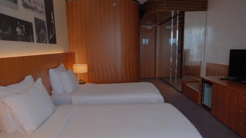 a hotel room with two beds and a television at Crowne Plaza Kayseri by IHG in Kayseri