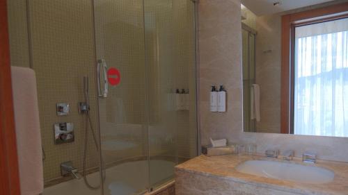 a bathroom with a shower and a sink and a tub at Crowne Plaza Kayseri by IHG in Kayseri
