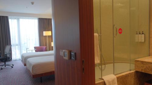 a hotel room with a bed and a shower at Crowne Plaza Kayseri by IHG in Kayseri