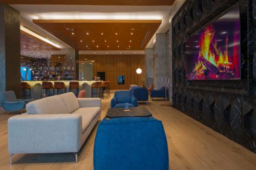a living room with a couch and a bar at Crowne Plaza Kayseri by IHG in Kayseri