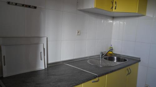 a kitchen with a sink and a counter top at Hôtel Prestige in Nouadhibou