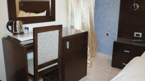 a mirror on a dresser in a hotel room at Hôtel Prestige in Nouadhibou