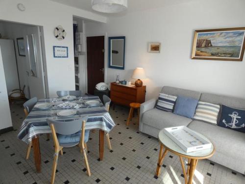 un salon avec une table et un canapé dans l'établissement Appartement 35m² proche plage avec balcon, parking et animaux admis - 4 personnes - FR-1-540-306, à Notre-Dame-de-Monts