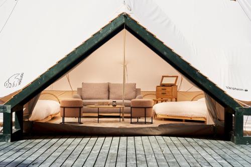 a living room in a tent with a couch at 五浦 幽谷隠田跡温泉 Hidden Traces of Rice Terraces Hot Spring - Izura in Kitaibaraki