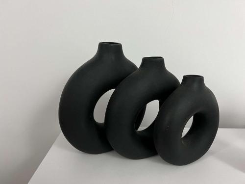 three black vases sitting next to each other at Modern Shared Studio in Heart of Zamalek in Cairo